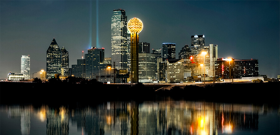 cityscape view alongside a lake at night