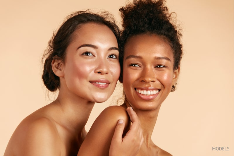 Beautiful young Asian and black women with glowing, flawless skin.