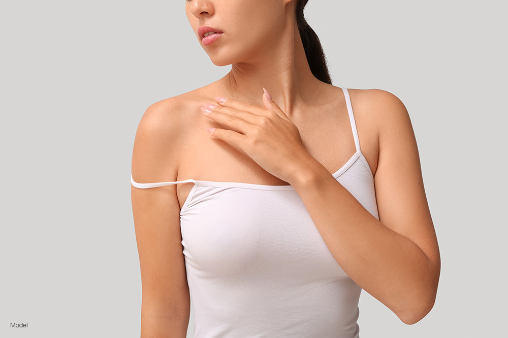 Young woman in white spaghetti strap